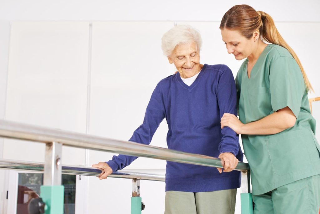 a senior undergoing physical therapy with support bars for walking